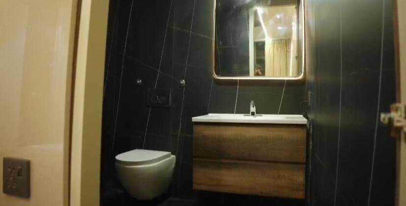 Washroom with wall-hung WC and timber vanity
