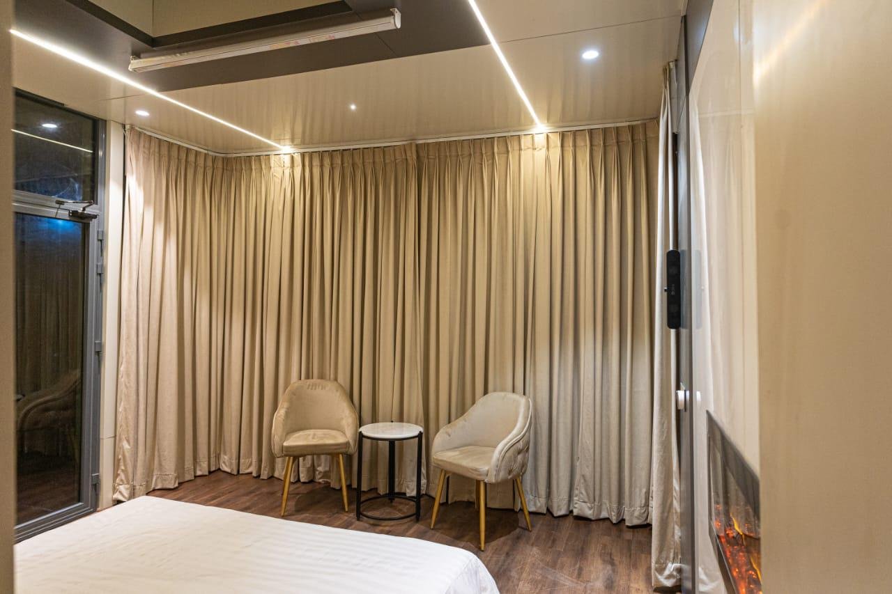 Capsule lounge with curtains, armchairs and LED ceiling lines