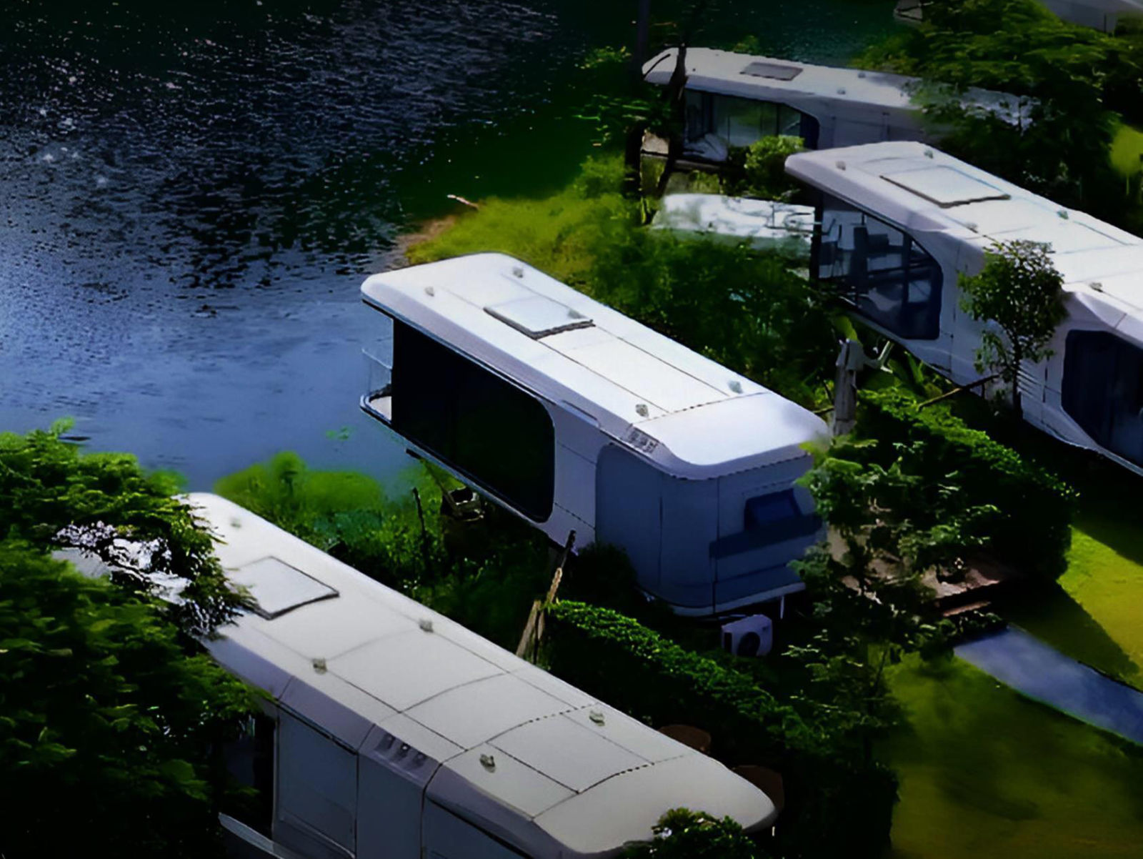 Aerial view of white capsule pods beside a lake